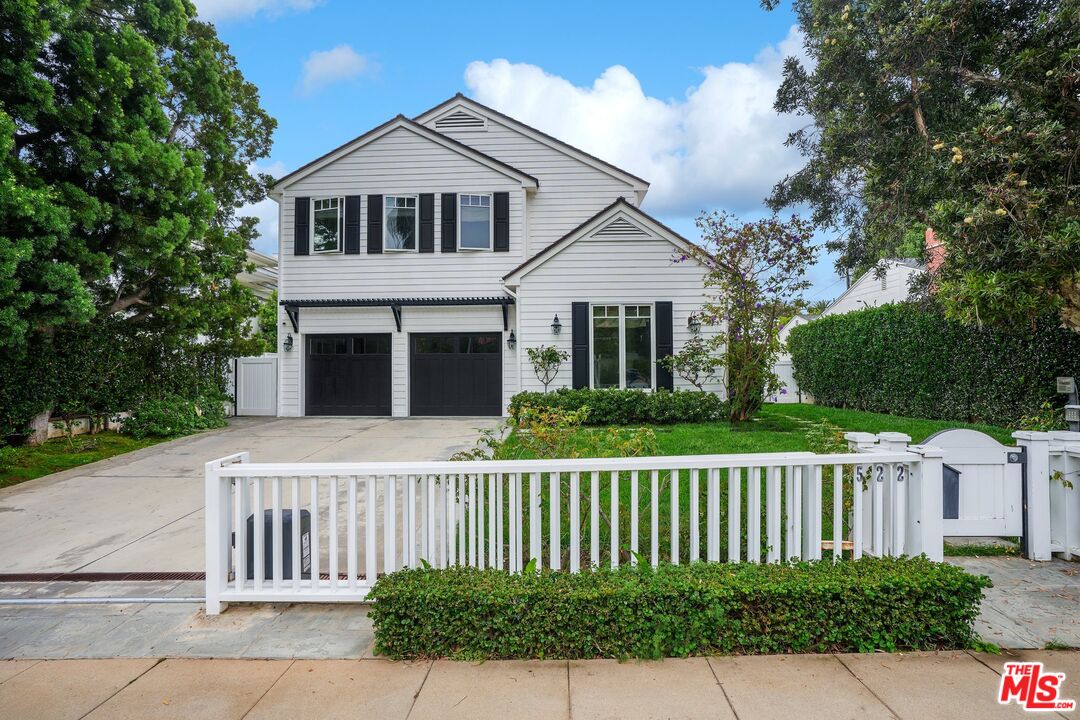 a front view of a house with a fence