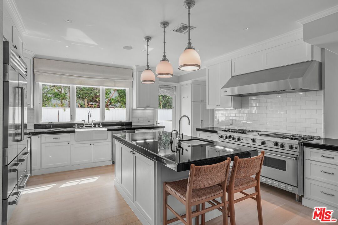 522 21st Street Santa Monica, CA 90402 - Photo 9 of 18 a kitchen with stainless steel appliances granite countertop a stove a sink and a refrigerator