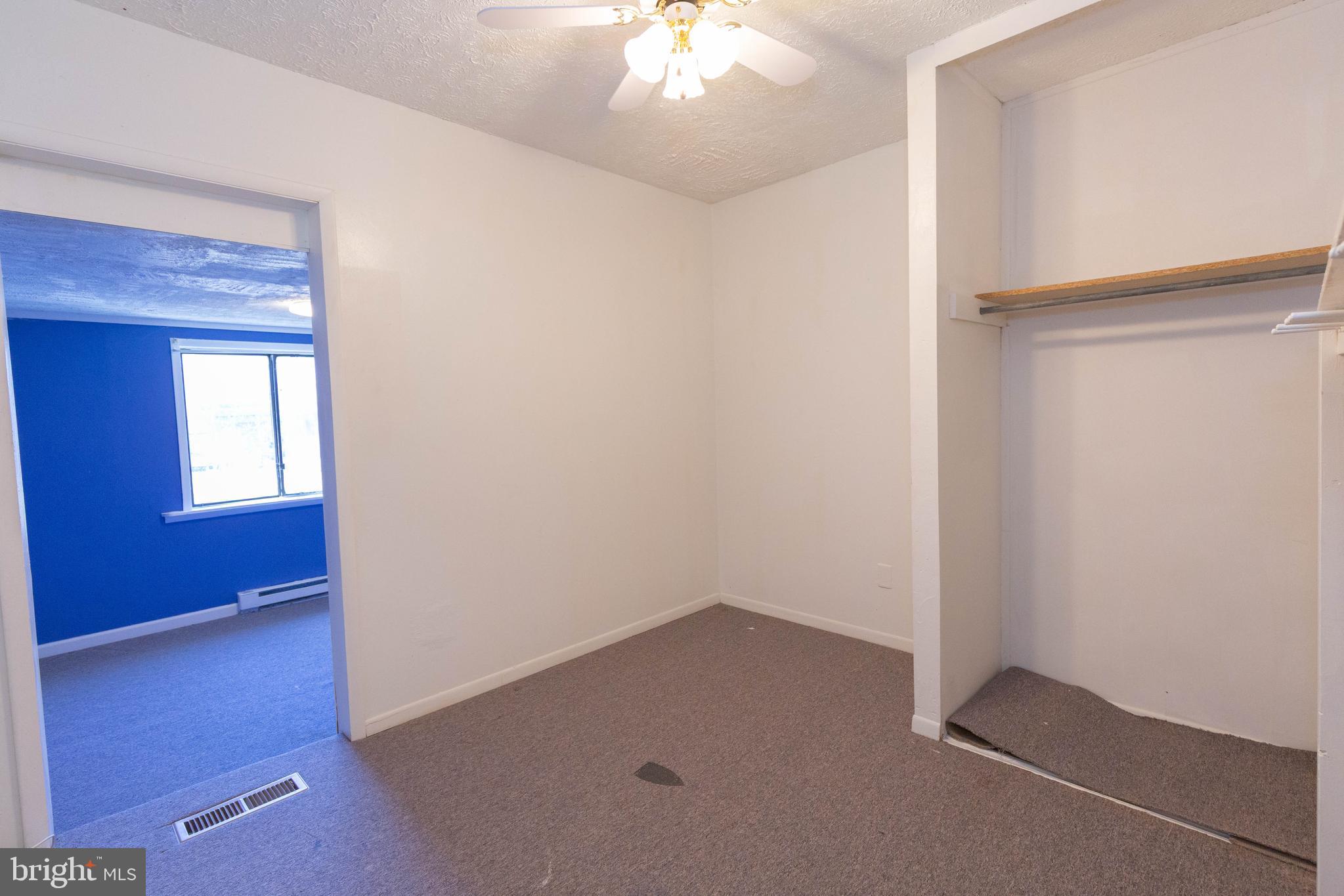 48 Turf Lane Ranson, WV 25438 - Photo 13 of 21 an empty room with a chandelier fan and a window