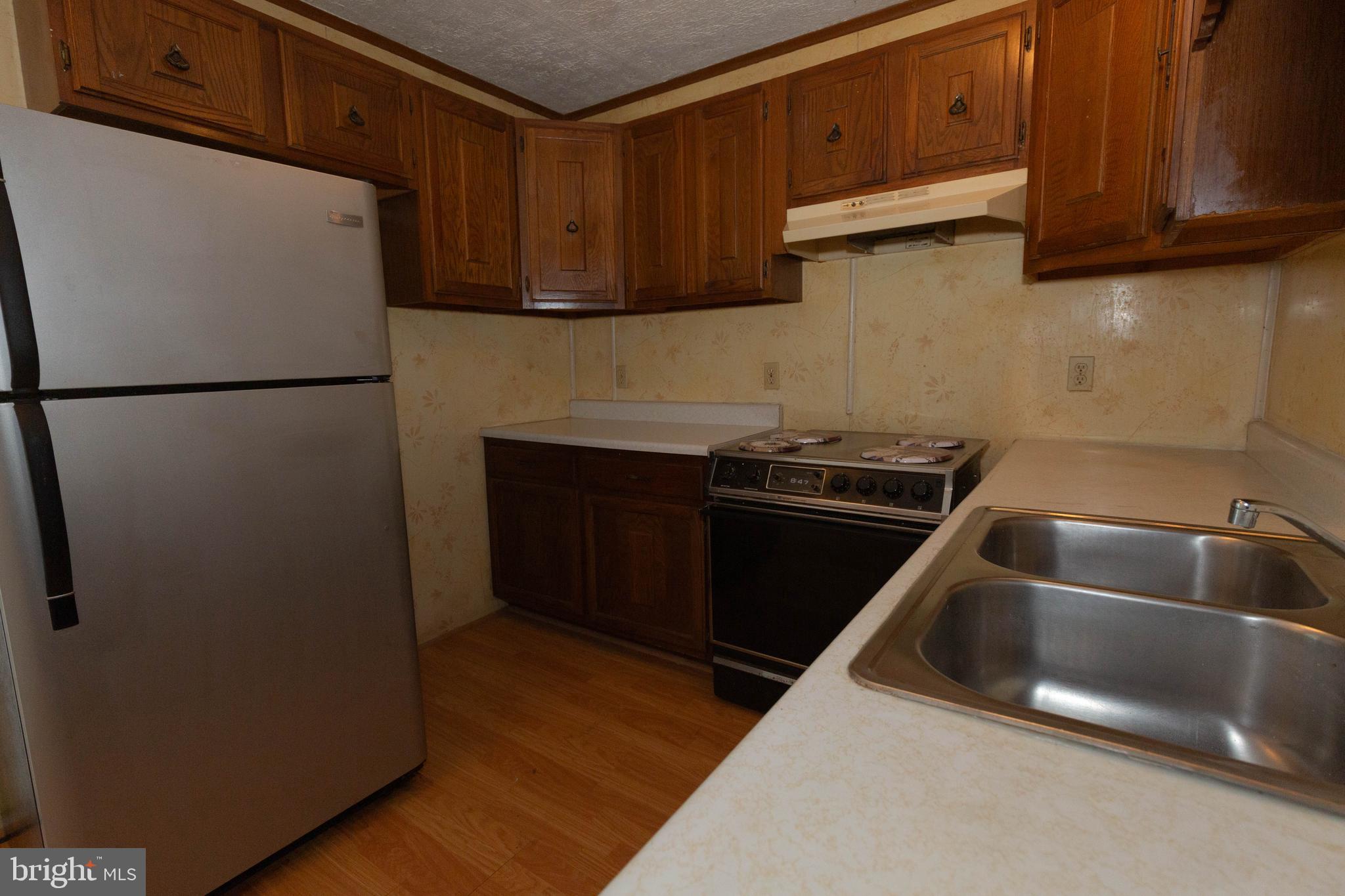 48 Turf Lane Ranson, WV 25438 - Photo 5 of 21 a kitchen with a refrigerator sink and cabinets