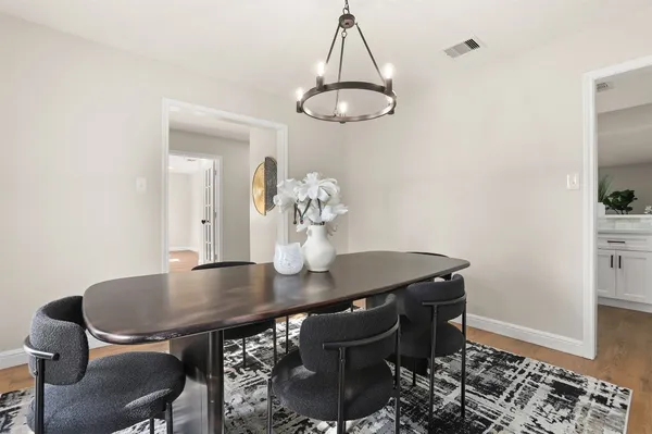 a dining room with a table and chairs