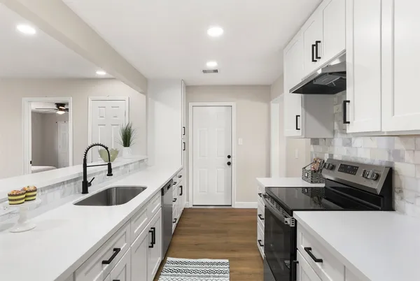 a kitchen that has a sink and a stove