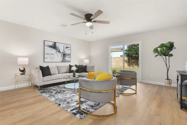 a living room with furniture and a potted plant