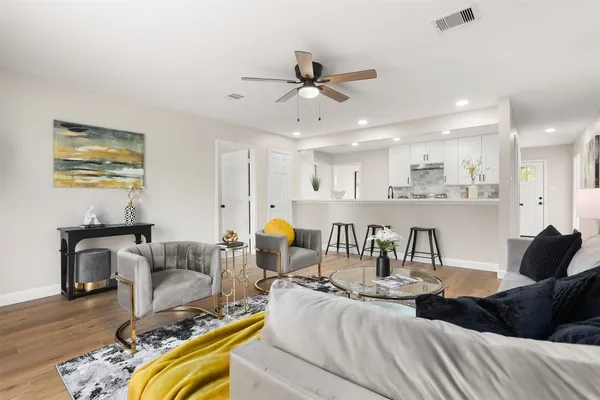 a living room with furniture and kitchen view