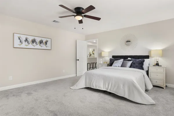 a bedroom with a bed and a painting on the wall