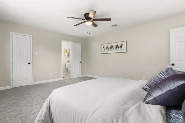 a bedroom with a bed and a ceiling fan