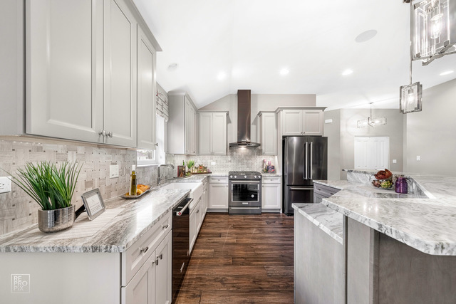 12854 Rosa Lane Lemont, IL 60439 - Photo 4 of 17 a kitchen with white cabinets and stainless steel appliances