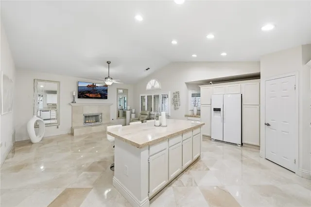 a living room with kitchen island furniture and a chandelier