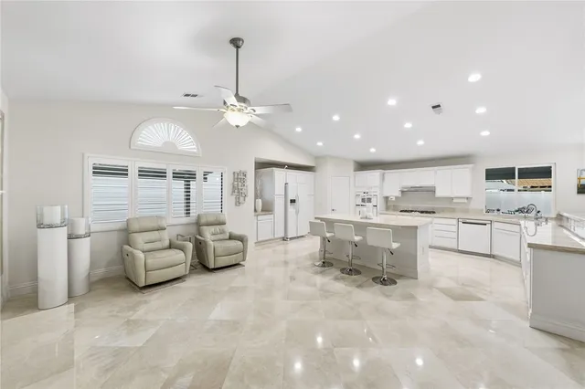a view of a hallway view with wooden floor and living room