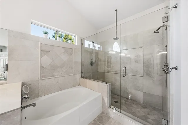 a view of walk in closet with clothes