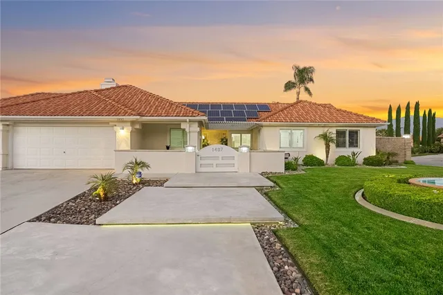 a view of a patio with couches table and chairs and potted plants