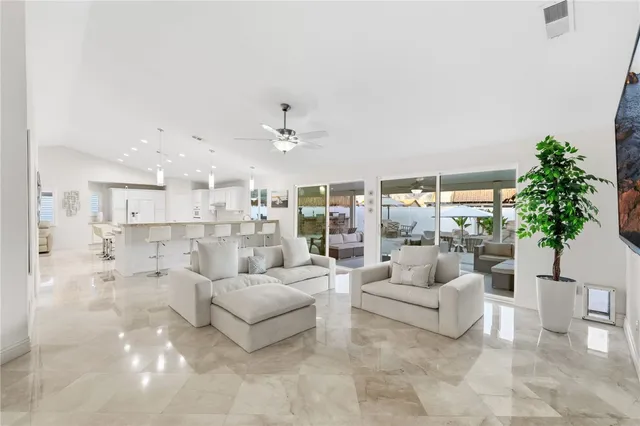 a large white kitchen with a table and chairs