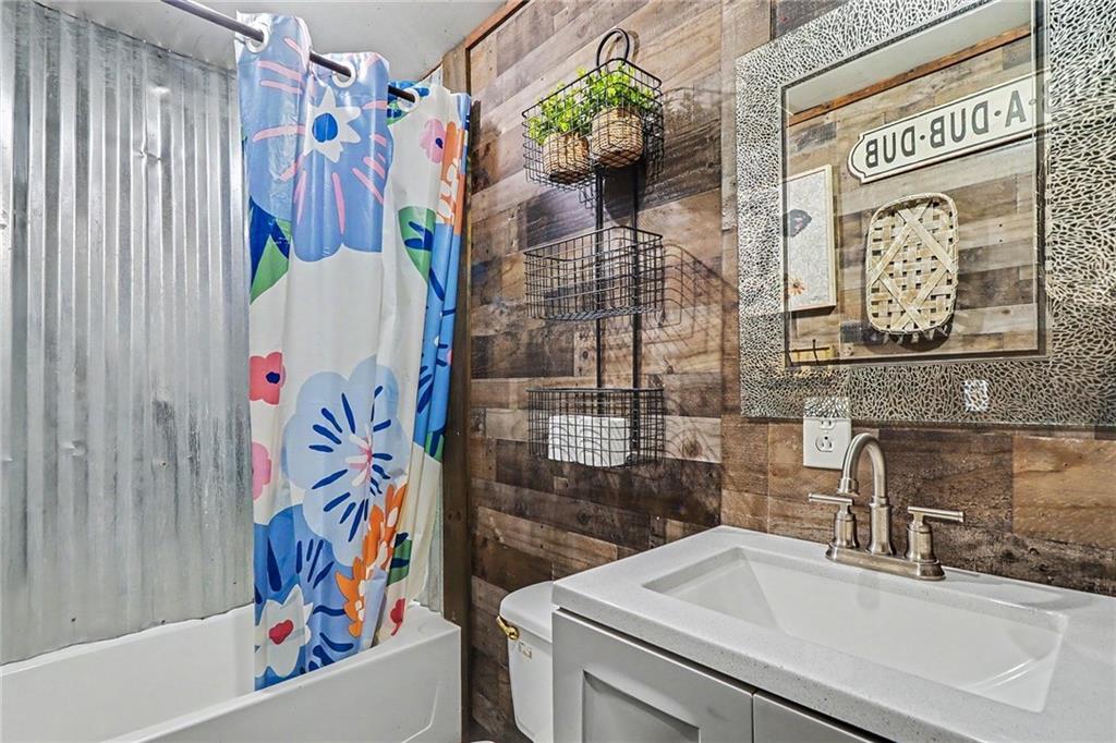 381 River Bend Road Southwest Plainville, GA 30733 - Photo 15 of 28 a bathroom with a sink and a shower curtain
