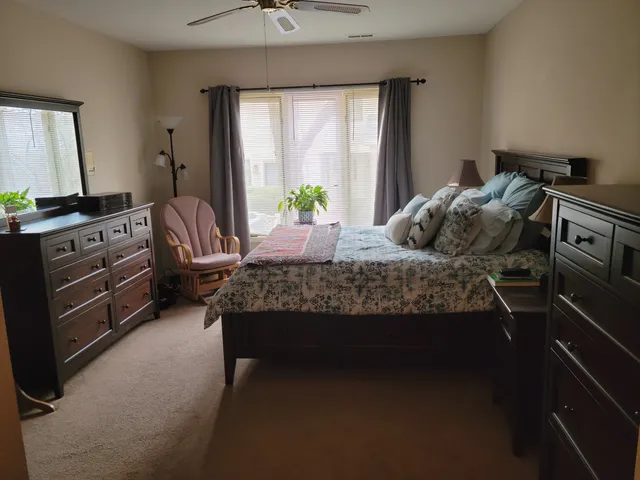 a bedroom with a bed and a dresser