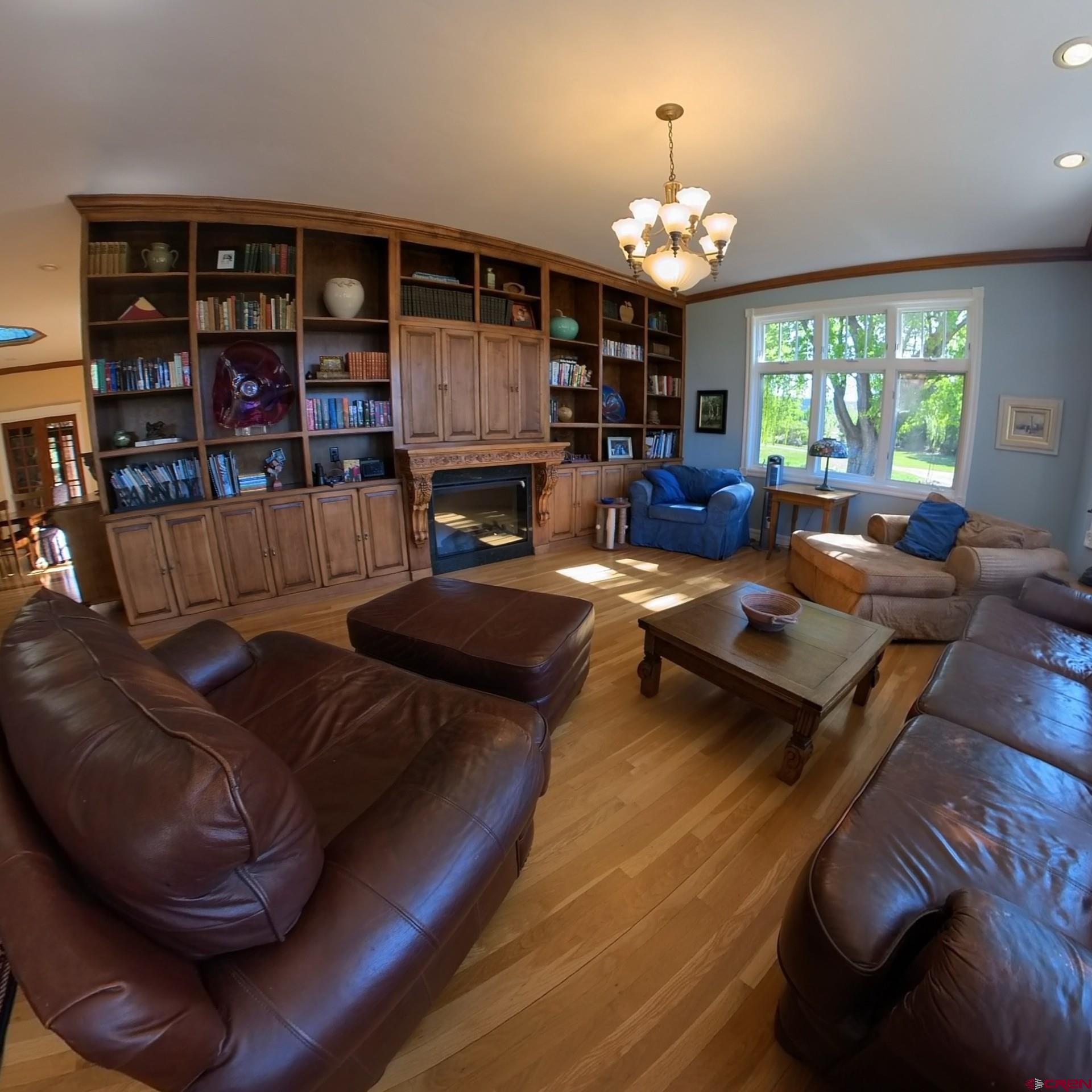 633 East Main Street Cedaredge, CO 81413 - Photo 14 of 32 a living room with furniture a chandelier and a large window