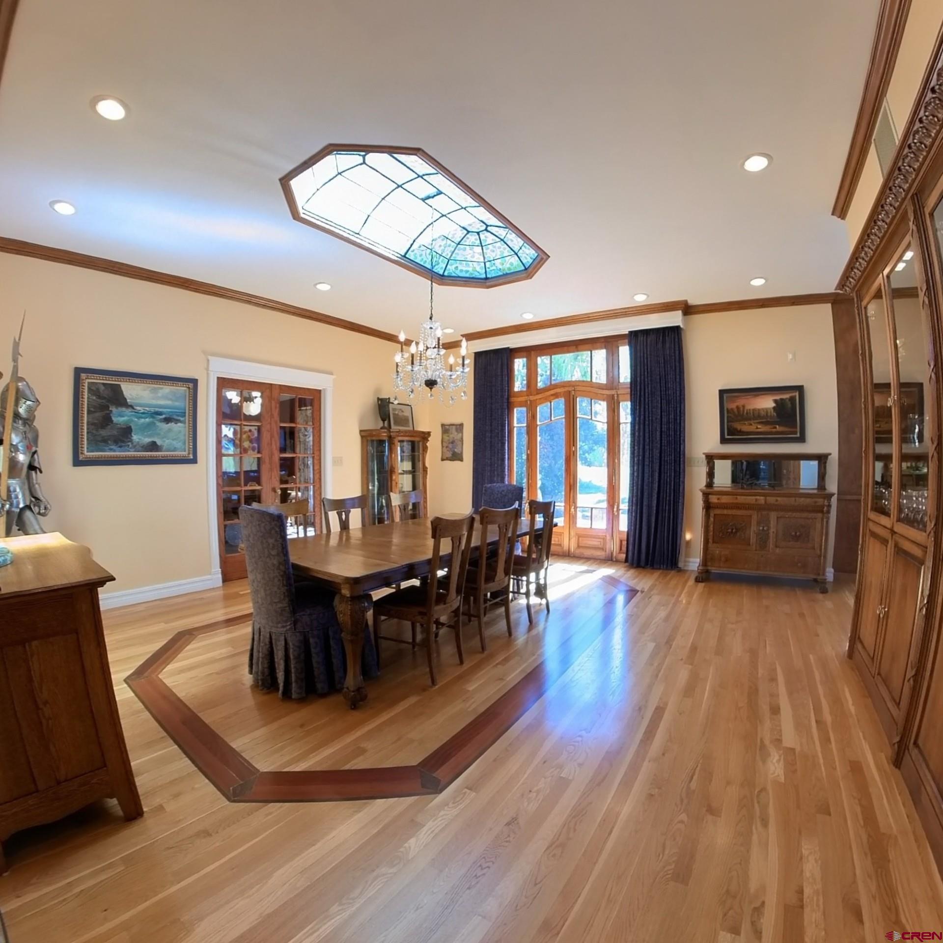 633 East Main Street Cedaredge, CO 81413 - Photo 17 of 32 a dining room with wooden floor a glass table and chairs