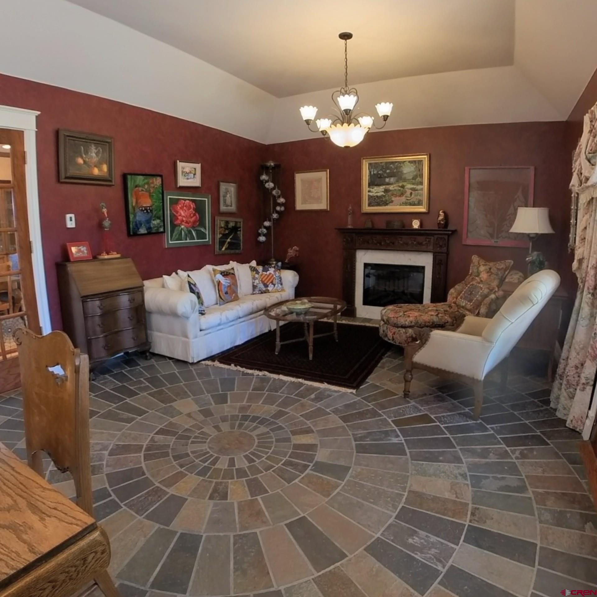 633 East Main Street Cedaredge, CO 81413 - Photo 24 of 32 a living room with furniture a chandelier and a fireplace