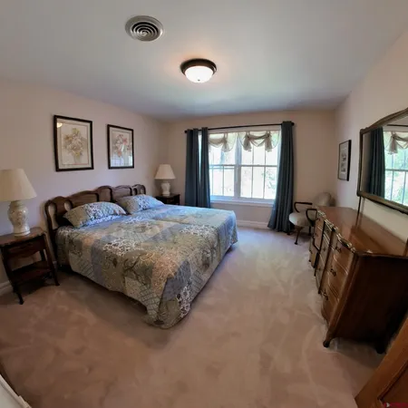 a bedroom with a bed gym equipment and a window