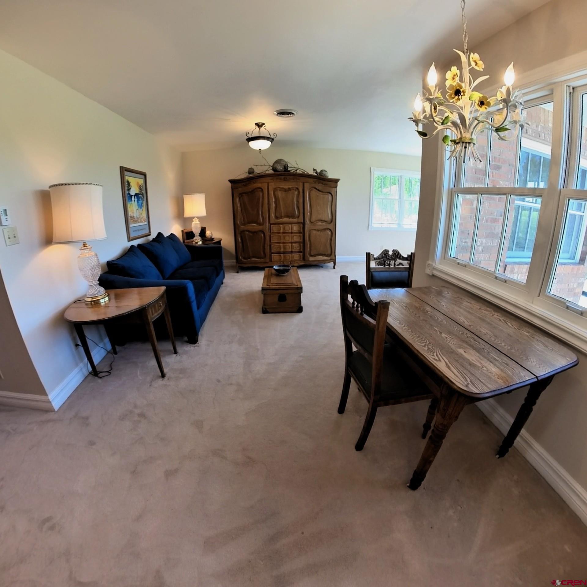 633 East Main Street Cedaredge, CO 81413 - Photo 30 of 32 a living room with furniture and a chandelier