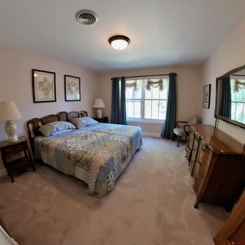 a bedroom with a bed gym equipment and a window