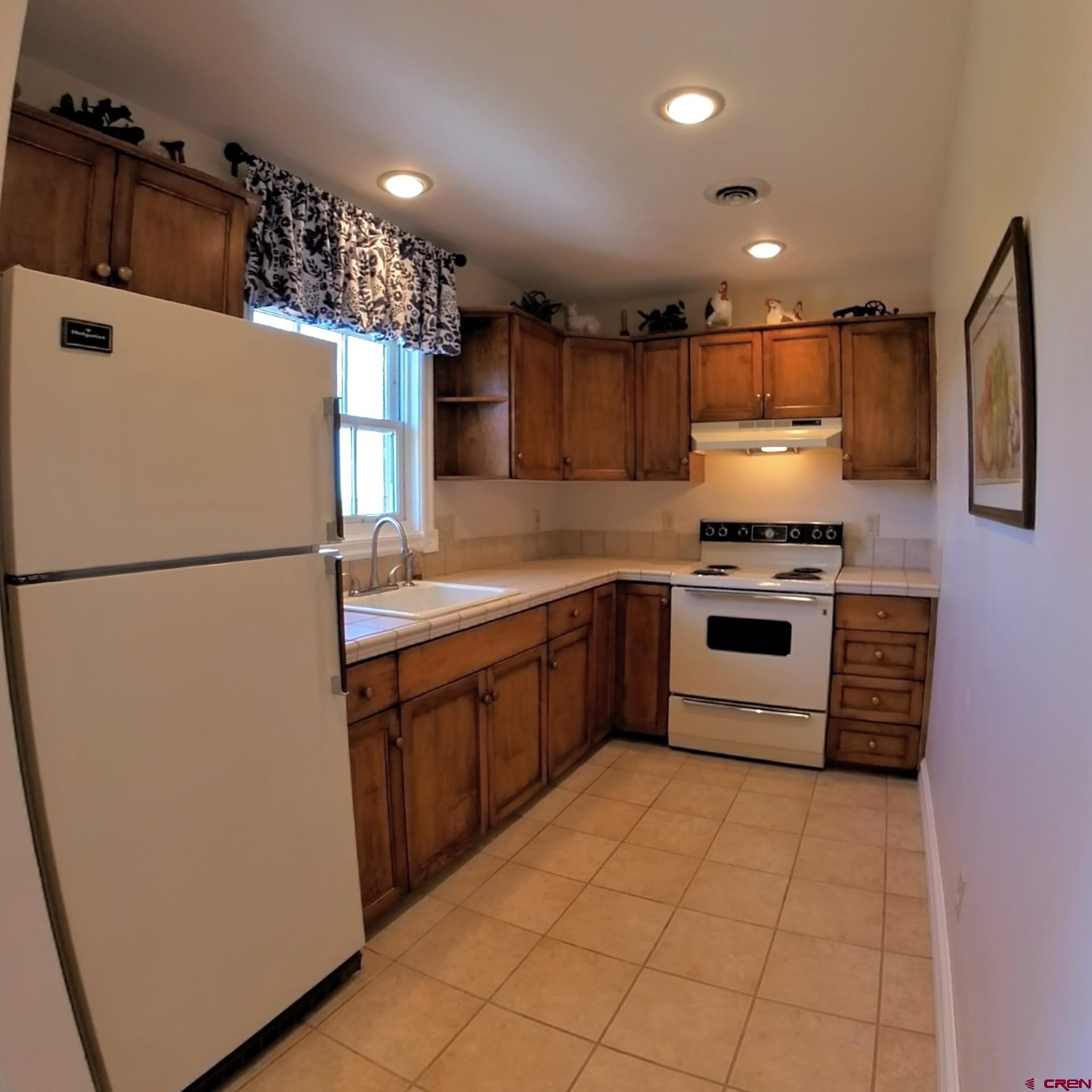 633 East Main Street Cedaredge, CO 81413 - Photo 31 of 32 a kitchen with stainless steel appliances granite countertop a refrigerator a stove a sink and a microwave