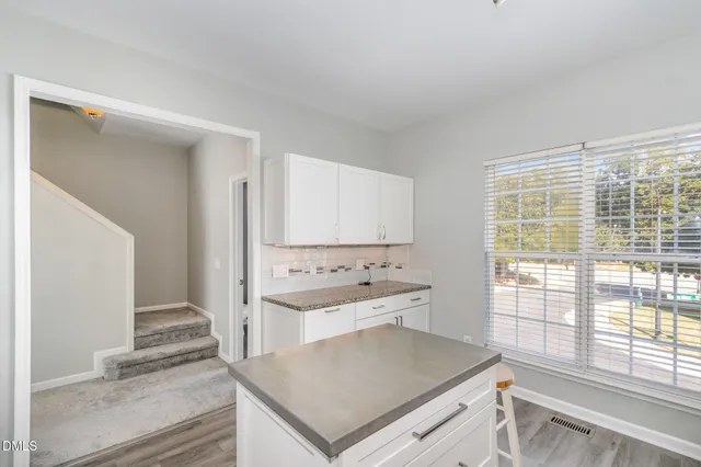 a kitchen with a stove a sink and a refrigerator