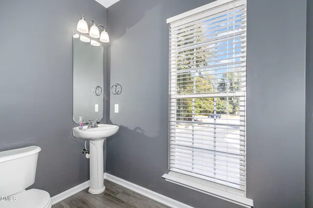 a bathroom with a toilet sink and window