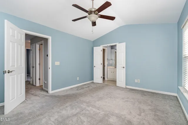 a view of an empty room with a ceiling fan