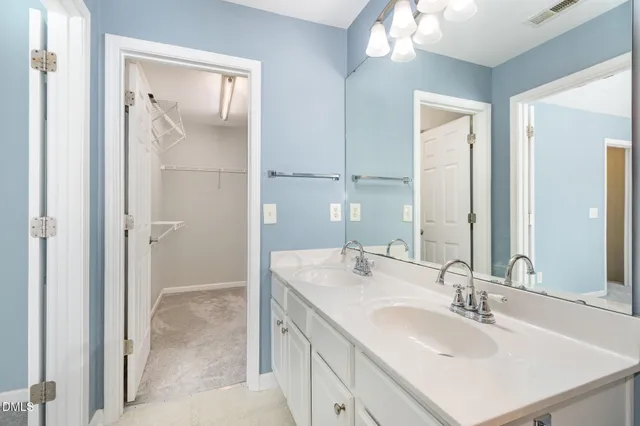 a bathroom with a sink double vanity and a mirror