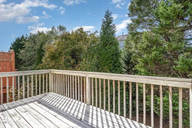 a balcony with wooden floor and fence