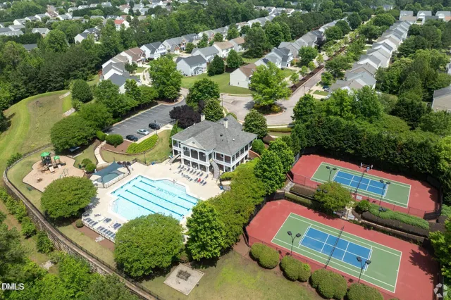 an aerial view of a pool patio fire pit and outdoor kitchen