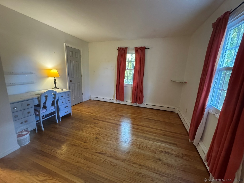 1166 Spindle Hill Road Wolcott, CT 06716 - Photo 15 of 29 a view of an empty room with wooden floor and a window
