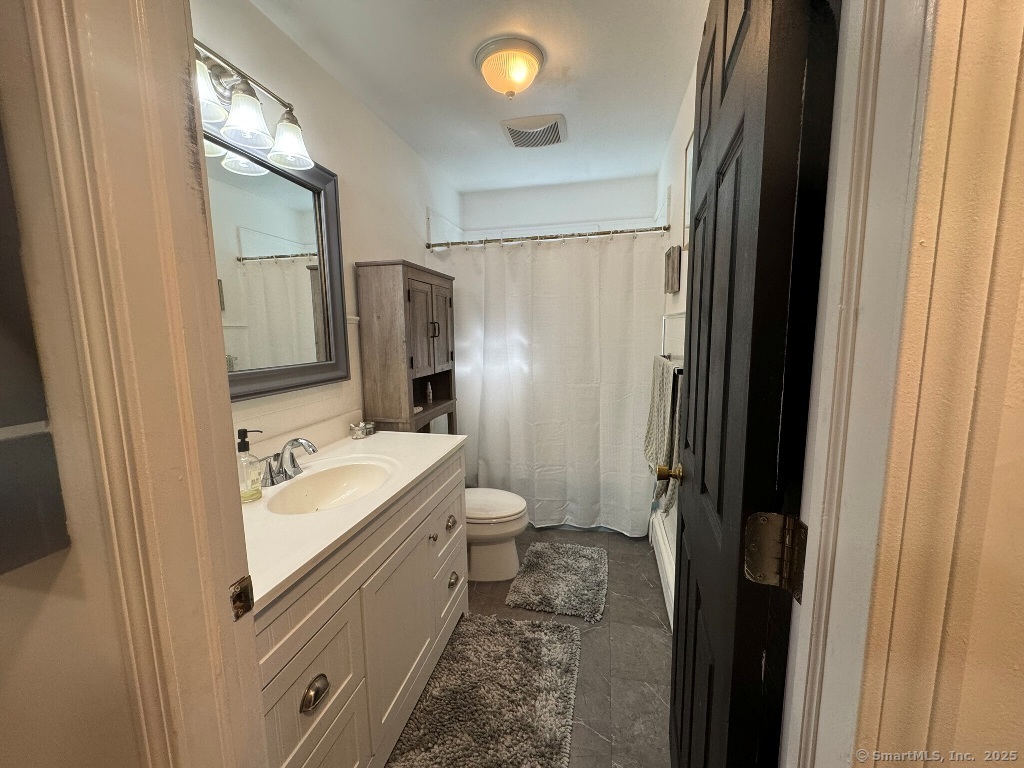 1166 Spindle Hill Road Wolcott, CT 06716 - Photo 16 of 29 a bathroom with a double vanity sink toilet and shower
