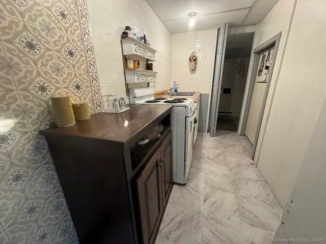 a kitchen with stainless steel appliances granite countertop a refrigerator and a stove