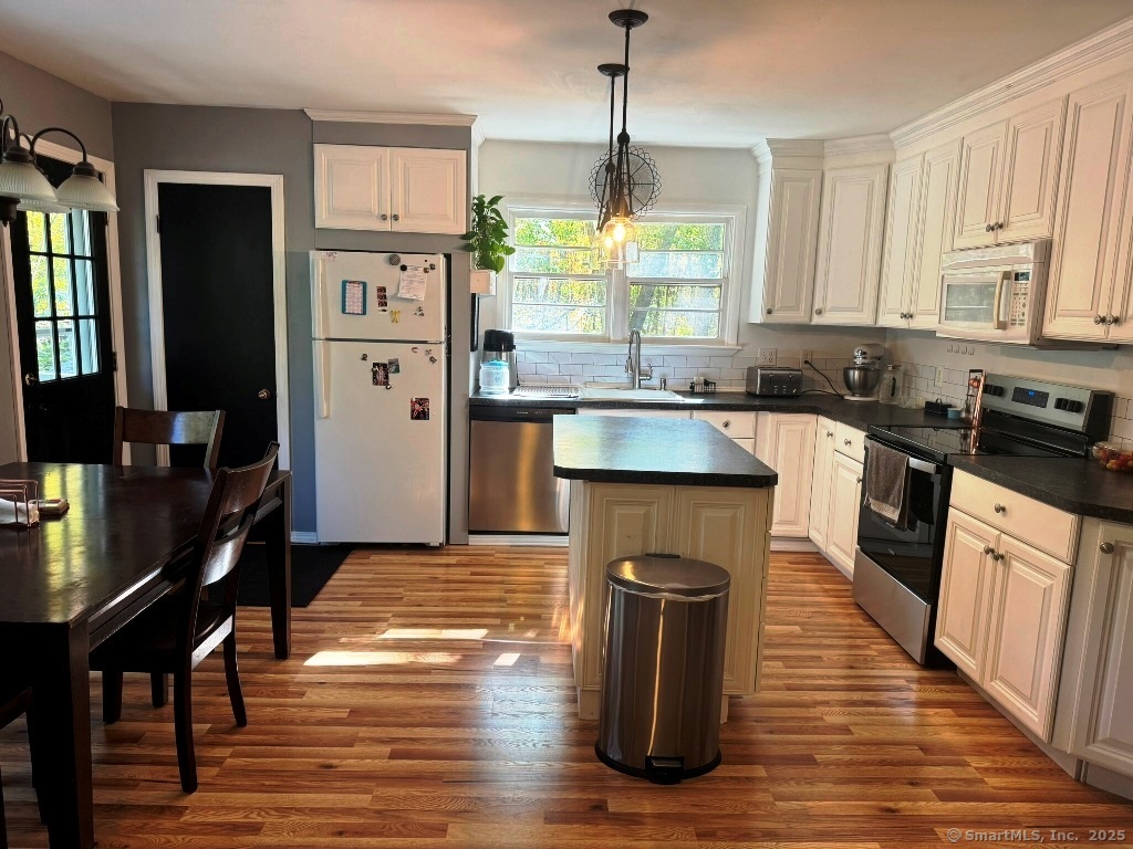 1166 Spindle Hill Road Wolcott, CT 06716 - Photo 2 of 29 a kitchen with stainless steel appliances granite countertop wooden floor sink stove and refrigerator