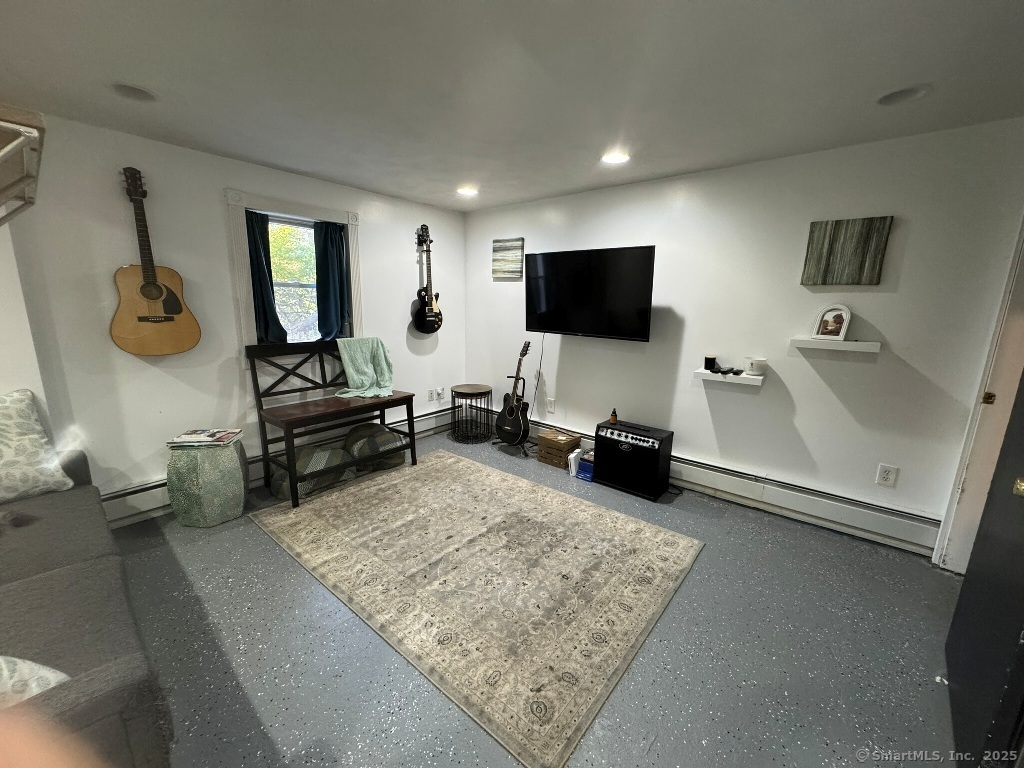 1166 Spindle Hill Road Wolcott, CT 06716 - Photo 21 of 29 a living room with furniture and a flat screen tv