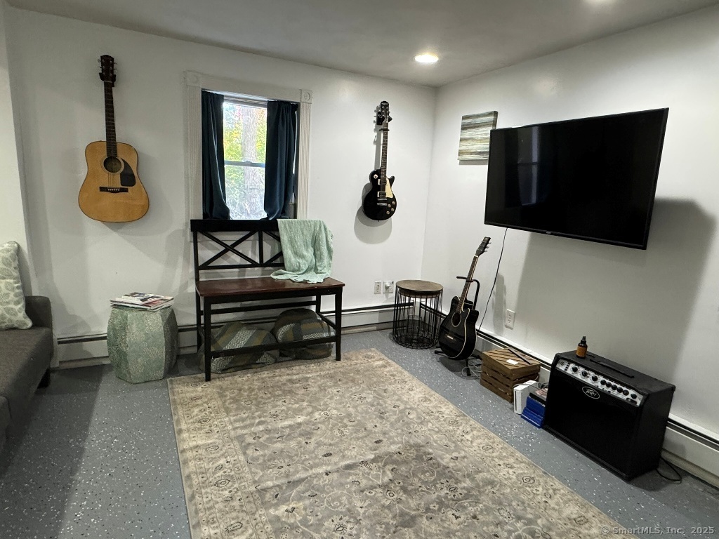 1166 Spindle Hill Road Wolcott, CT 06716 - Photo 22 of 29 a living room with furniture and a flat screen tv