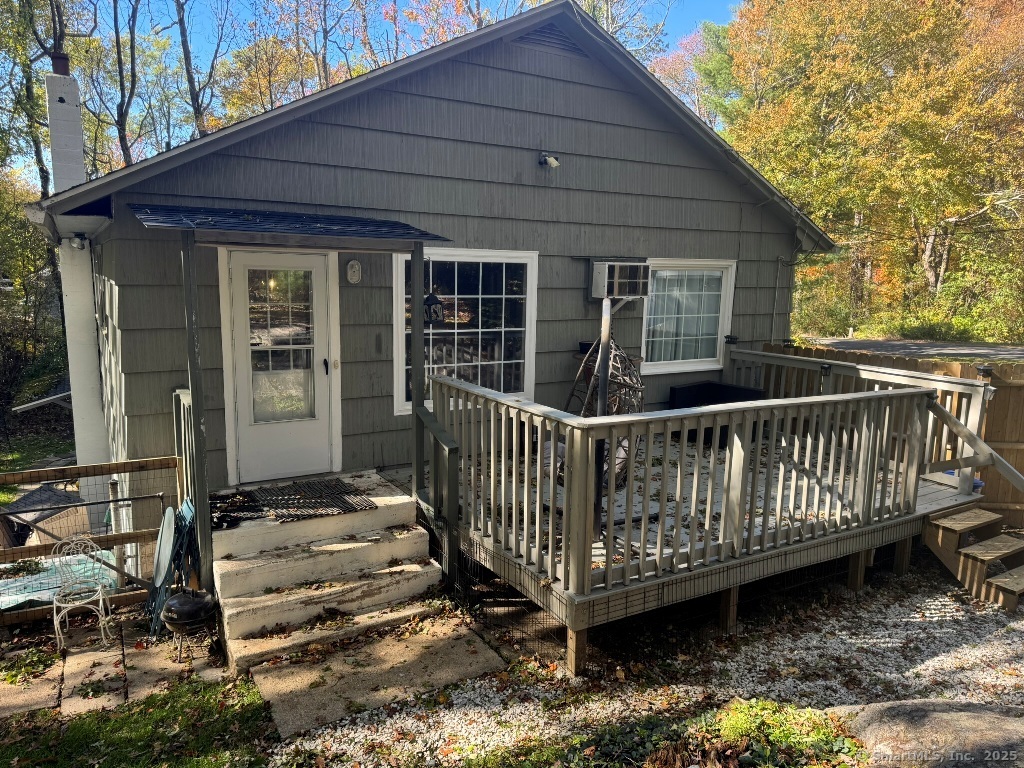 1166 Spindle Hill Road Wolcott, CT 06716 - Photo 24 of 29 a view of a wooden house with a wooden deck