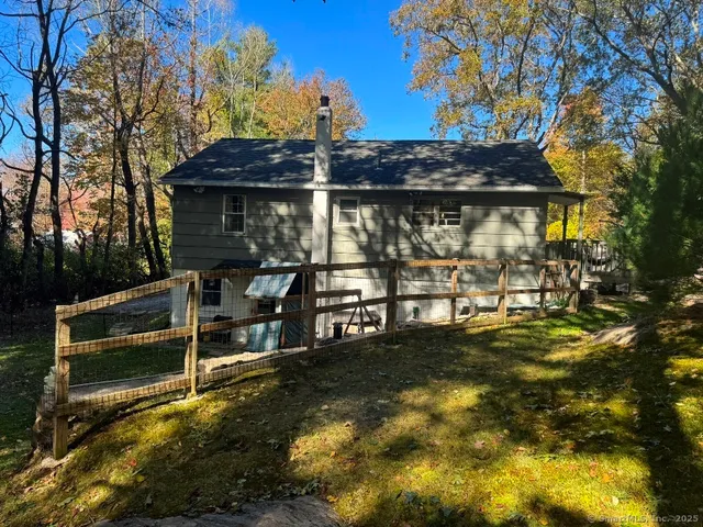 a view of a patio with table and chairs under an umbrella