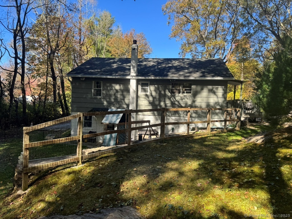 1166 Spindle Hill Road Wolcott, CT 06716 - Photo 25 of 29 a view of a patio with table and chairs under an umbrella
