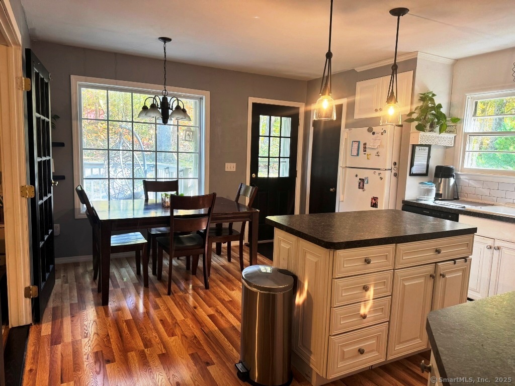 1166 Spindle Hill Road Wolcott, CT 06716 - Photo 4 of 29 a kitchen with granite countertop a table chairs stove and sink