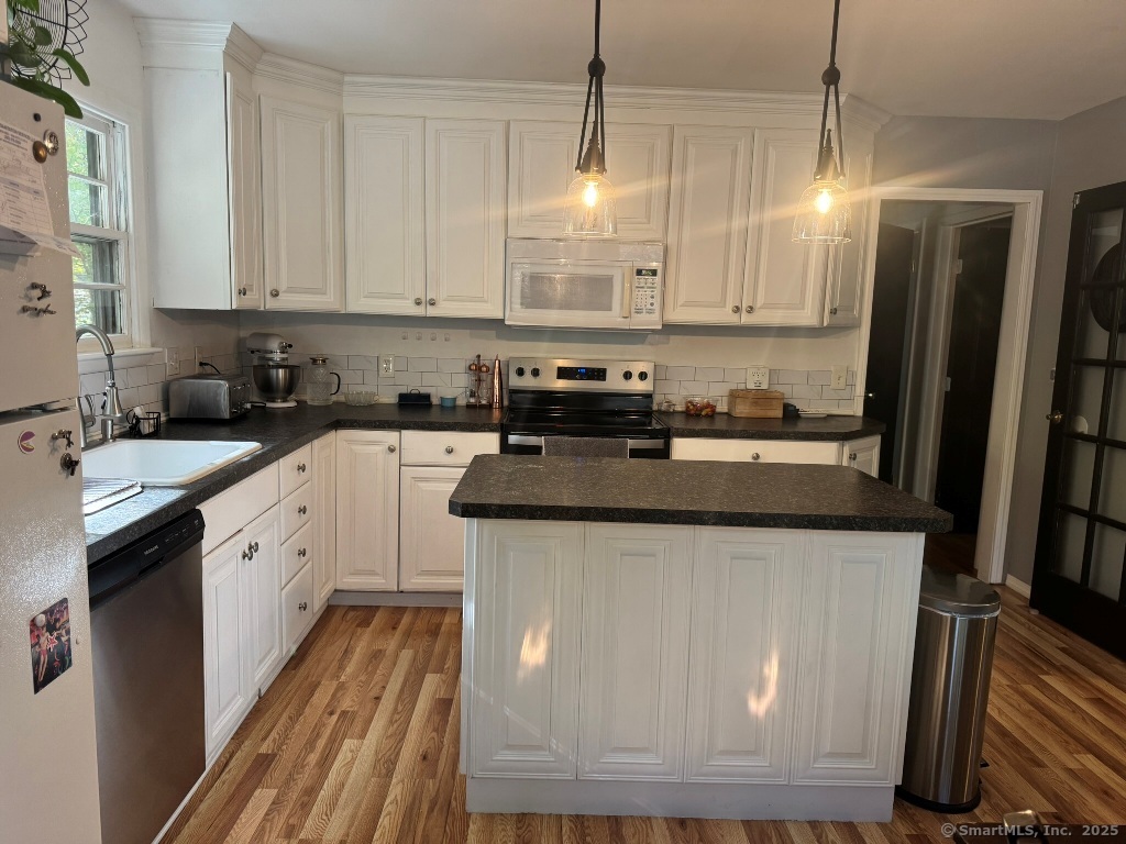 1166 Spindle Hill Road Wolcott, CT 06716 - Photo 5 of 29 a kitchen with stainless steel appliances granite countertop a sink a stove and a refrigerator