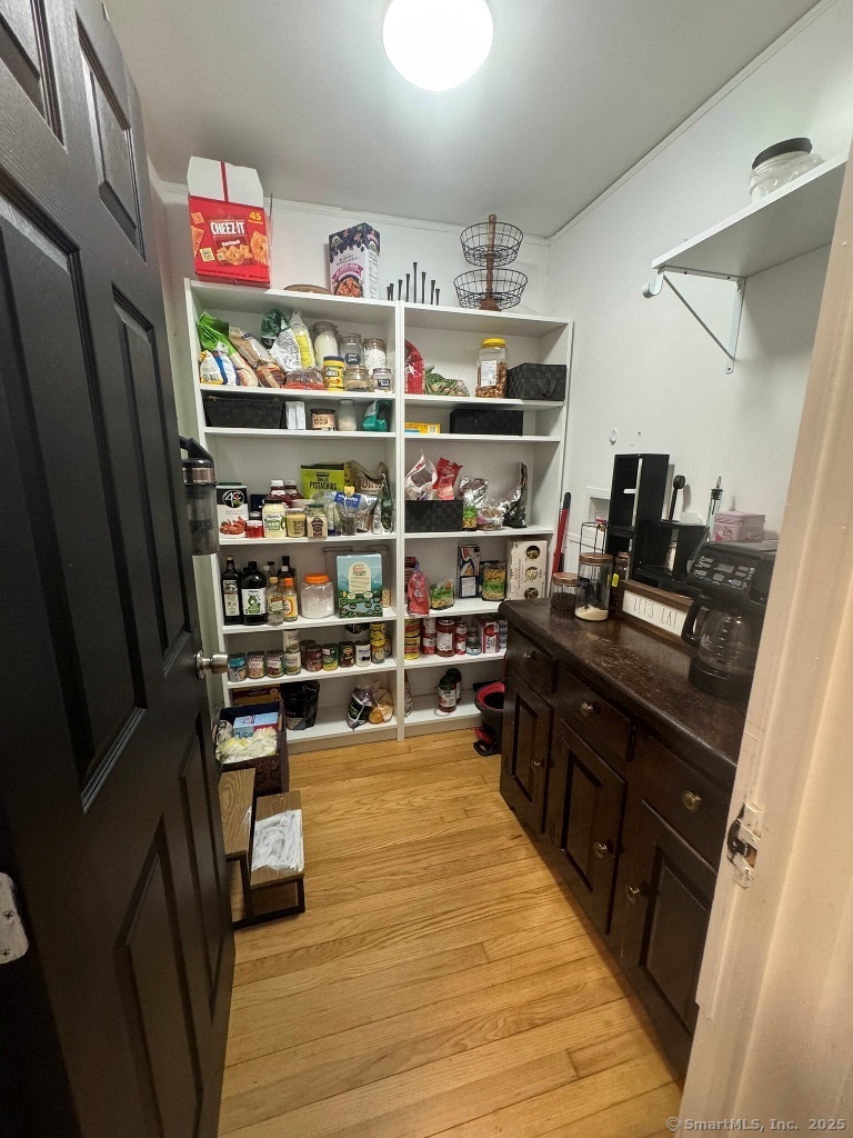 1166 Spindle Hill Road Wolcott, CT 06716 - Photo 6 of 29 a kitchen with stainless steel appliances a refrigerator and a wooden floor