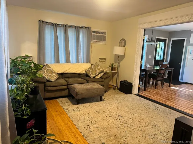 a bedroom with furniture and wooden floor