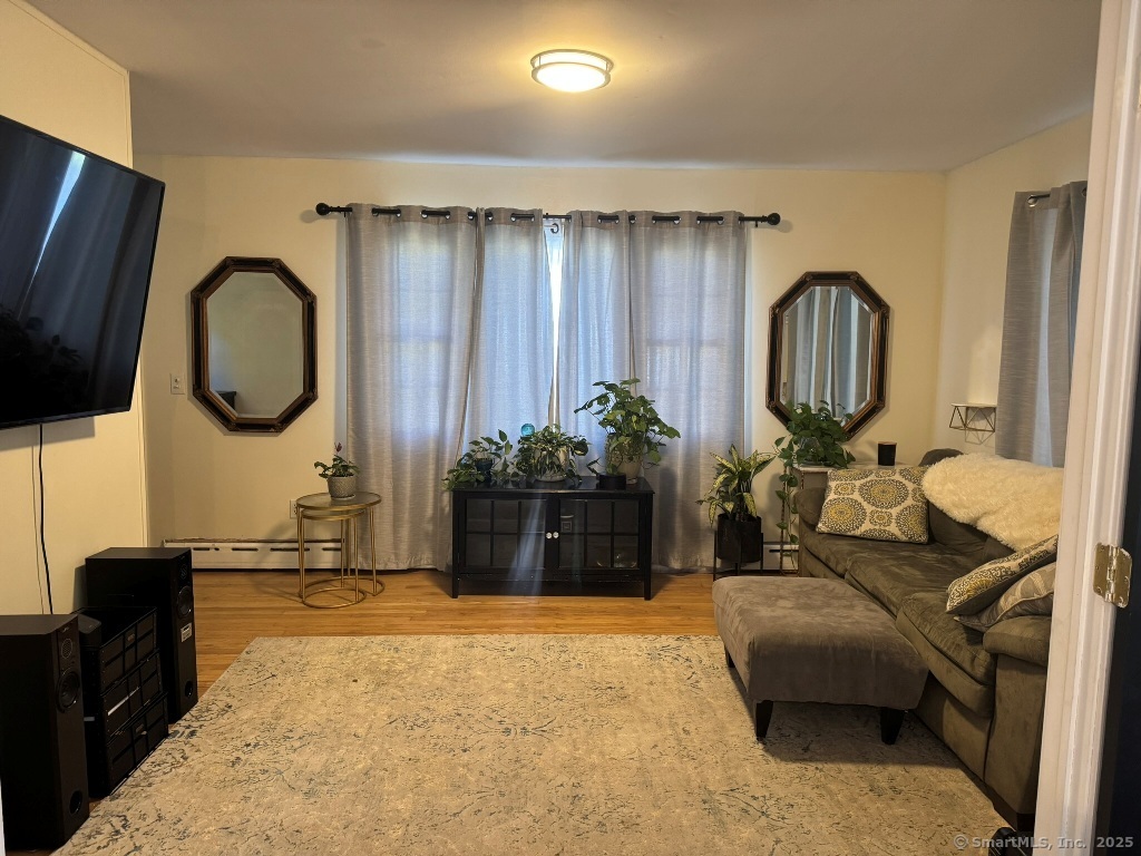 1166 Spindle Hill Road Wolcott, CT 06716 - Photo 9 of 29 a living room with furniture a large window and a potted plant