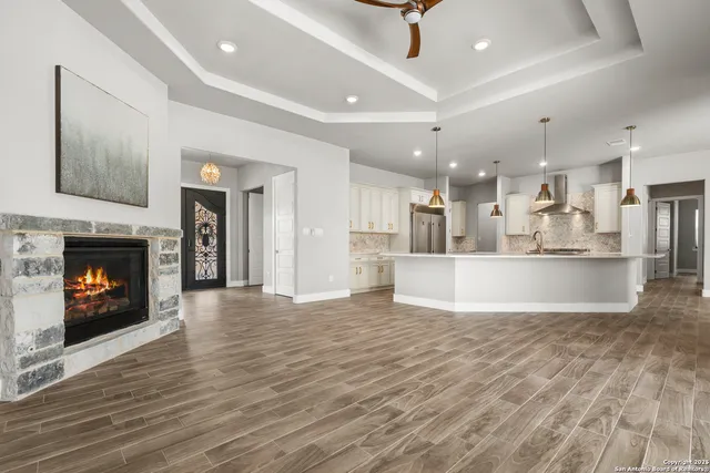 a view of kitchen and kitchen with furniture and a fireplace