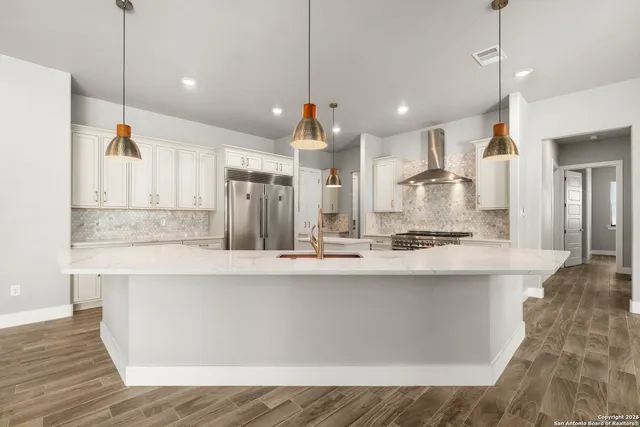 a large kitchen with stainless steel appliances kitchen island a large island in the center