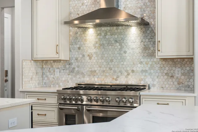 a stove top oven sitting inside of a kitchen