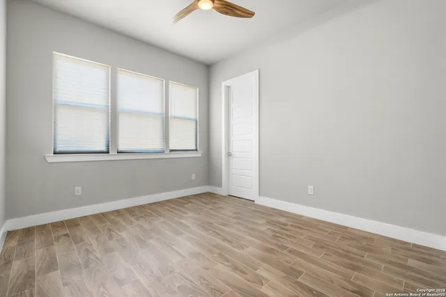 an empty room with windows and closet