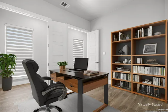 a bedroom with a bed a couch and a flat screen tv